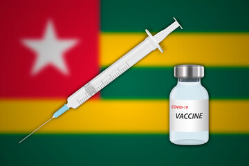 Syringe and vaccine vial on blur background with Togo flag,