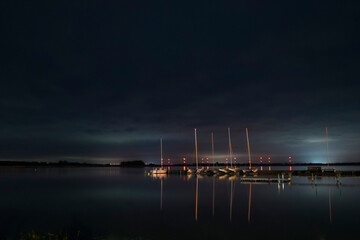 Fototapeta na wymiar Langzeitbelichtung mit Sternenhimmel und Spiegelung im Wasser am Hafen