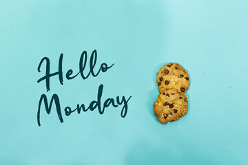 chocolate cookies and hello monday isolated on blue background