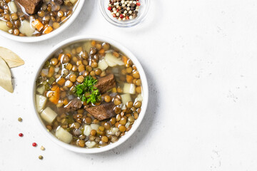 Detox green lentil soup in bowls. Space for text, flat lay, top view.