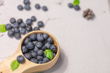 Fresh blueberries in a wooden mug. Natural vitamins concept
