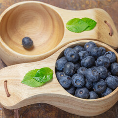 Fresh blueberries in a wooden mug. Natural vitamins concept