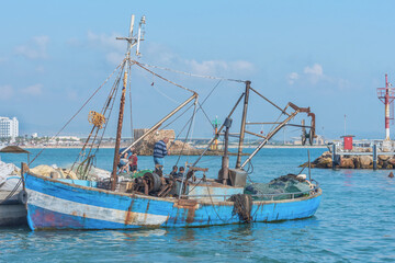 Fototapeta na wymiar Old fish boat in Akko, the coastal ancient city in Israel