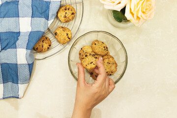 hands woman eating Chocolate Chip Cookies