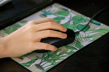 Hand of a mouse on a mousepad