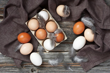 Chicken colorful eggs on wooden table