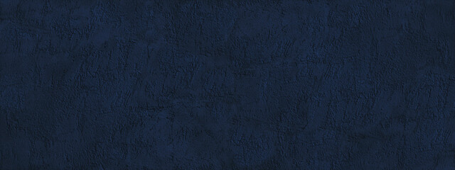 Navy blue abstract background. Dark blue toned texture of a rough plastered concrete wall....