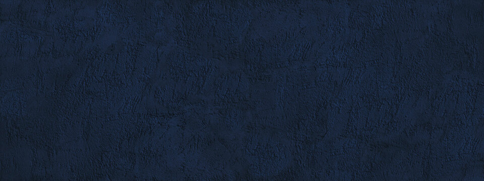 Navy blue abstract background. Dark blue toned texture of a rough plastered concrete wall. Monochrome background with copy space for design. Wide banner.