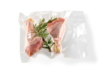 Chicken thighs and rosemary in vacuum packed sealed for sous vide cooking, isolated on white background