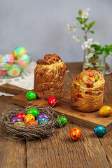 Easter cake Kraffin (Cruffin), with nuts and candied fruit sprinkled with powdered sugar, 2021 trend of the easter cake. Vertical image with a place for printing.