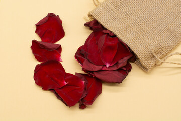 red rose petals on a beige background. Minimal style flat lay. For greeting card, invitation. March 8, February 14, birthday, Valentine's, Mother's, Women's day concept.