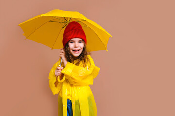 happy girl kid laughing with yellow umbrella on colored beige background.