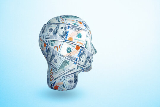 human head made by 100 dollar banknotes. Idea to earn money. The concept of money addiction, working only for money, business, startup, career.