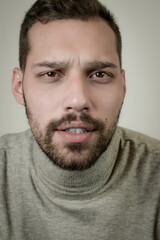Obraz premium Portrait of a young man with a short beard looking worried about something 