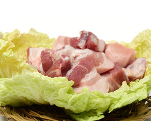Raw pork belly pieces on a white background