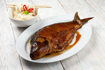 baked fish carp with sesame seeds, chili, ginger and soy sauce
