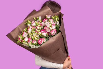 The girl with big bouquet of wrapped flowers