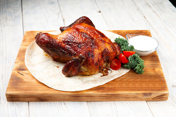 whole roasted chicken on wooden cutting board