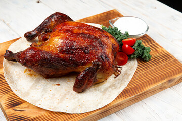 whole roasted chicken on wooden cutting board