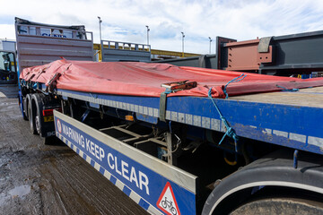 Semi Truck Trailer with a Load of Steel Sheeted with a Tarp