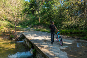 Girl with bike in the forest