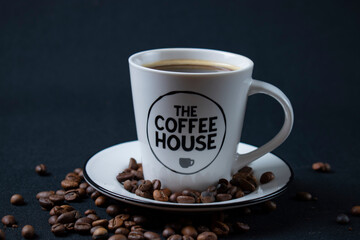 white coffee cup with coffee and beans