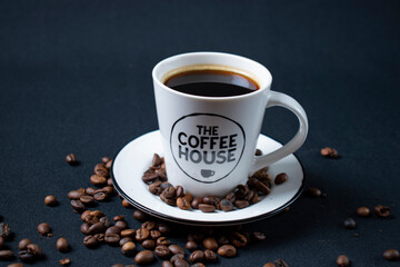 white coffee cup with coffee and beans