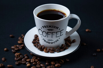 white coffee cup with coffee and beans