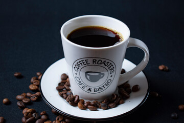 white coffee cup with coffee and beans