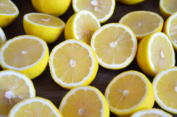 Fresh lemon halves on wooden background