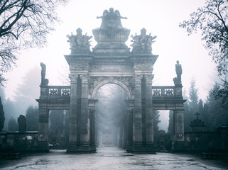 sandstone cemetery portal in fog at Hořice, Czechia