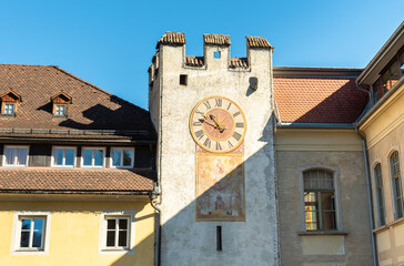 Fototapeta na wymiar Tower with clock of Ursuline Gate in the historic city of Bruneck or Brunico, South Tyrol, Italy