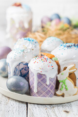 Easter table with Easter cakes and Easter eggs over white background