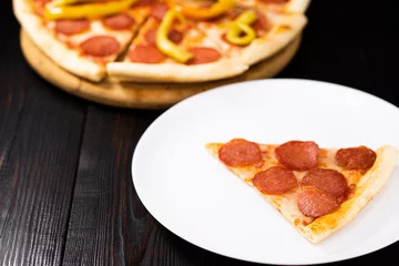 Foto op Plexiglas Slice of pepperoni pizza on a white plate © Oleksandr