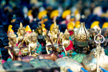 miniature buddha statues on a roadside store as a souvenir for tourists looking for handmade items...