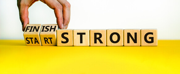 Start and finish strong symbol. Businessman turns wooden cubes, changes words 'start strong' to...