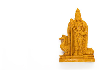 The wooden statue of Lord Murugan is isolated on a white background