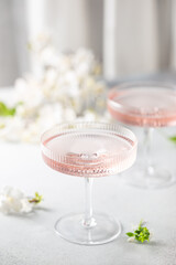 Fototapeta na wymiar Homemade pink vodka cosmopolitan cocktail drink in crystal glasses