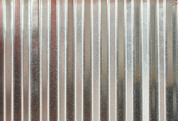 A view of a pleated sheet metal as a wall facade background.