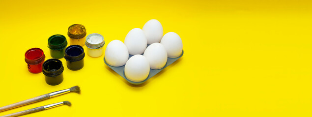 Easter eggs on a yellow background. Painting Easter eggs with paints