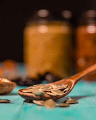 Pumpkin seeds and honey in jars on wooden blue color table in Rustic style. Autumn Season food photo