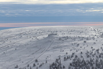 A view to the rocky peak of mountain covered by snow