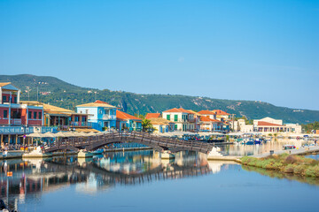 Fototapeta na wymiar Lefkas (Lefkada) town, amazing view at the small marina for the fishing boats with the nice wooden bridge and promenade, Ionian island, Greece