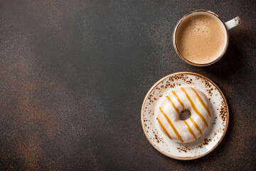 Cup of coffee and caramel donut
