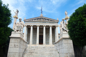 Fototapeta na wymiar The Academy of Athens is a neoclassical building in the centre of Athens. The statues of Plato and Socrates on the stairs in front of it