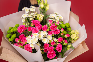 The girl holding big bouquet of flowers