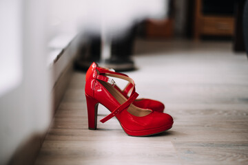 photo of a red high heels shoes on the floor
