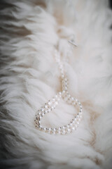 photo of a bride's pearl necklace on fur