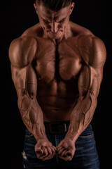 Fototapeta na wymiar Muscled male model flexing biceps