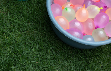 Container filled with water ballons. Copy space © Monica